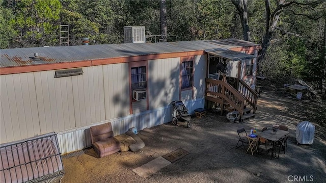view of home's exterior featuring metal roof and a patio area