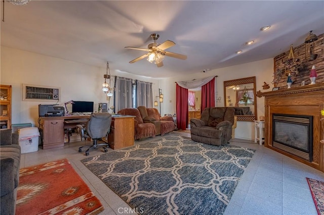 living area with ceiling fan and a glass covered fireplace
