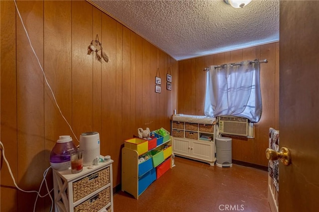 interior space with tile patterned floors, a textured ceiling, and wooden walls