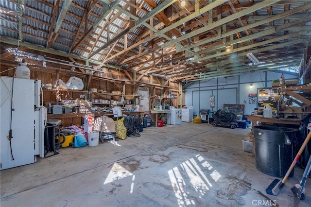 garage with washer / clothes dryer and a workshop area