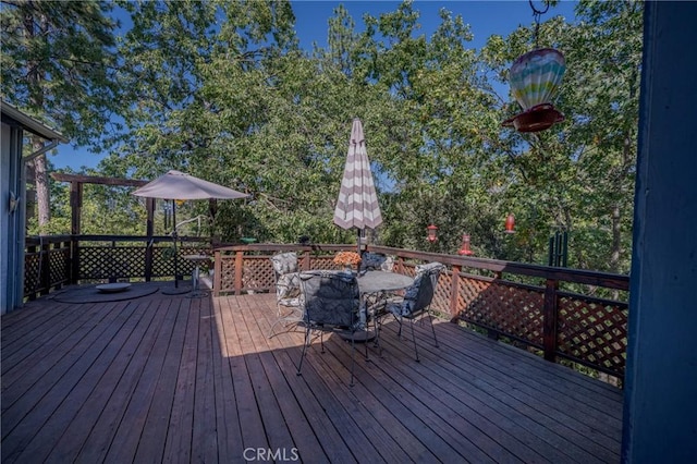 wooden deck featuring outdoor dining area