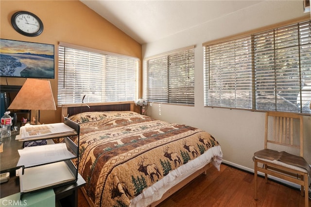 bedroom with hardwood / wood-style floors and lofted ceiling