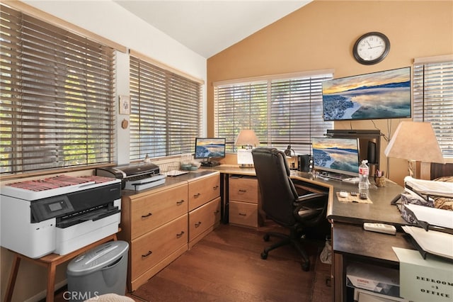 home office with dark wood-type flooring, a healthy amount of sunlight, and vaulted ceiling