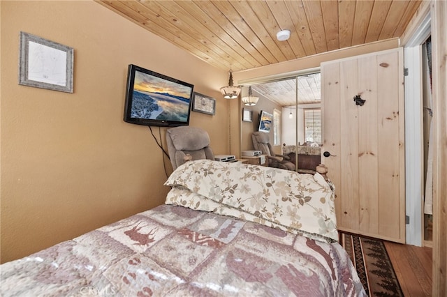 bedroom with a closet, hardwood / wood-style floors, and wood ceiling