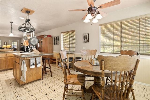 dining area with ceiling fan and a healthy amount of sunlight