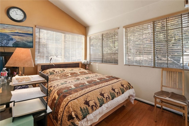 bedroom featuring hardwood / wood-style floors and vaulted ceiling