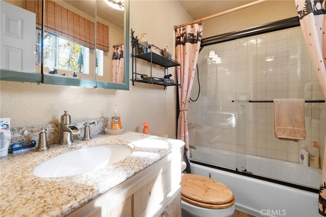 full bathroom with shower / tub combo with curtain, vanity, and toilet