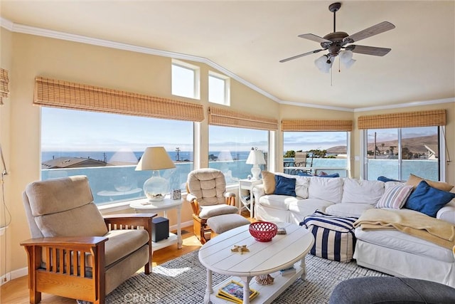 sunroom / solarium featuring ceiling fan, lofted ceiling, and a water view