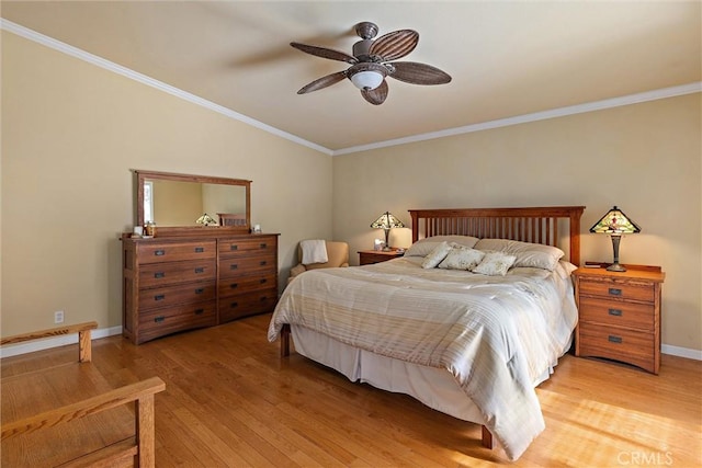 bedroom with ceiling fan, vaulted ceiling, ornamental molding, and hardwood / wood-style floors