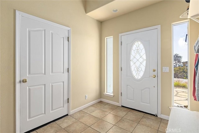 entryway featuring light tile patterned floors and a healthy amount of sunlight