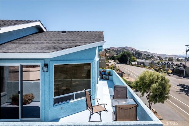 exterior space featuring a balcony and a mountain view