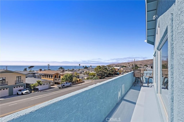 balcony featuring a water view