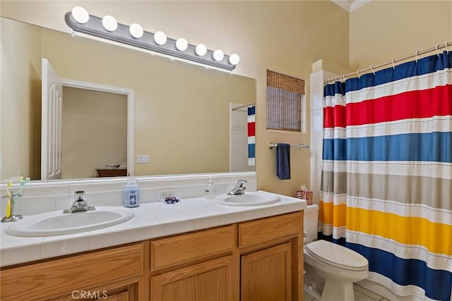 bathroom with toilet, vanity, and walk in shower