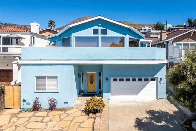 view of front of property featuring a garage and a balcony