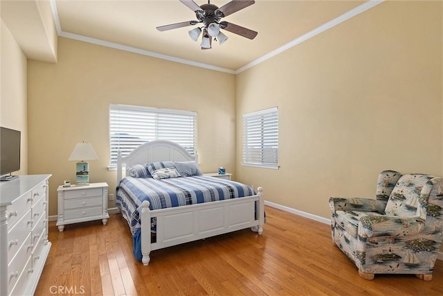 bedroom with ceiling fan, crown molding, and light hardwood / wood-style flooring