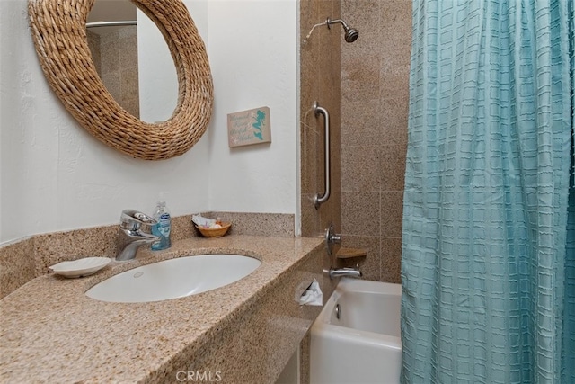 bathroom featuring shower / bath combo with shower curtain and sink