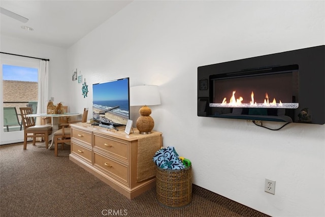 interior space featuring ceiling fan and a fireplace