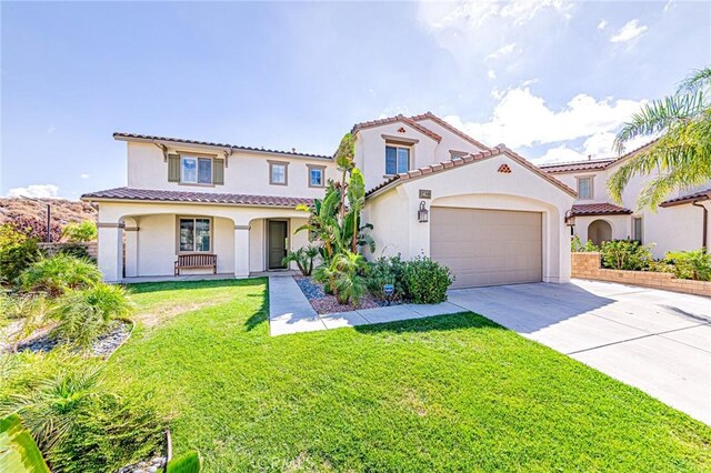 mediterranean / spanish house with covered porch and a front yard