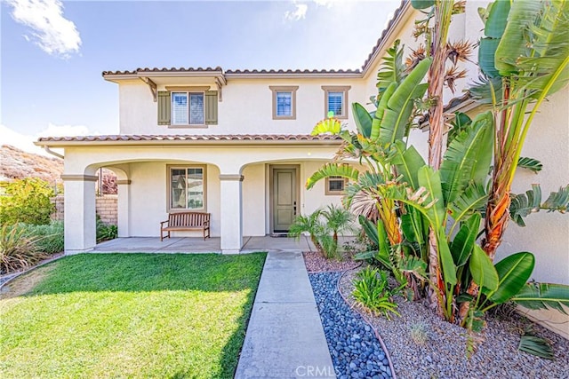 mediterranean / spanish-style house featuring a front lawn