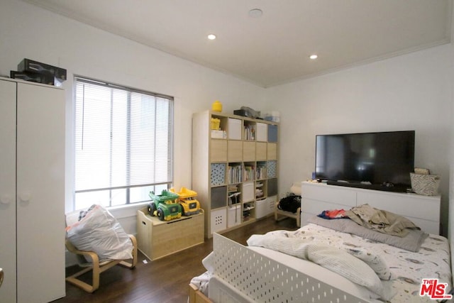 bedroom with dark hardwood / wood-style floors, multiple windows, and ornamental molding