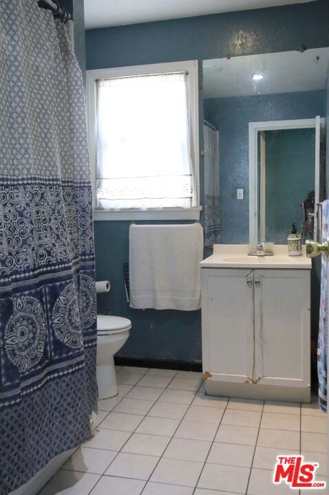 bathroom with tile patterned floors, vanity, and toilet