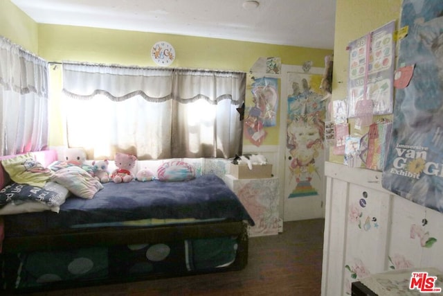 bedroom with dark hardwood / wood-style flooring