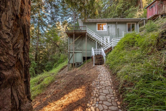 rear view of house featuring a wooden deck