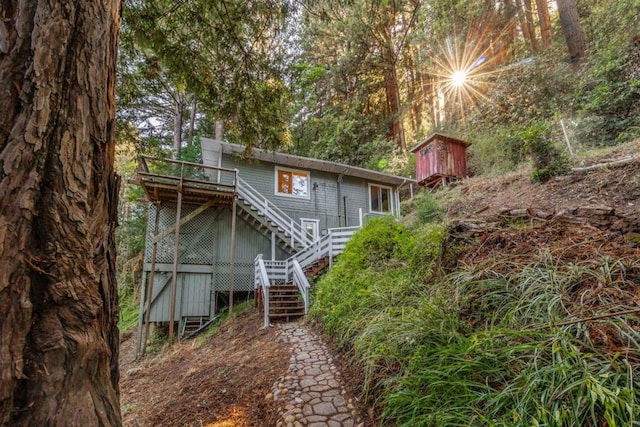 rear view of property featuring a wooden deck