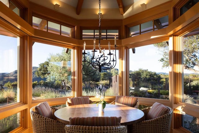 sunroom featuring an inviting chandelier