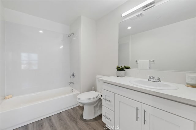 full bathroom featuring wood-type flooring, vanity, bathing tub / shower combination, and toilet