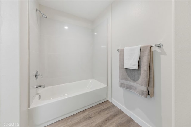 bathroom featuring wood-type flooring and washtub / shower combination