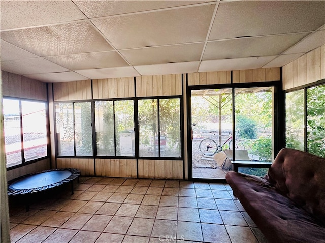 unfurnished sunroom featuring a paneled ceiling