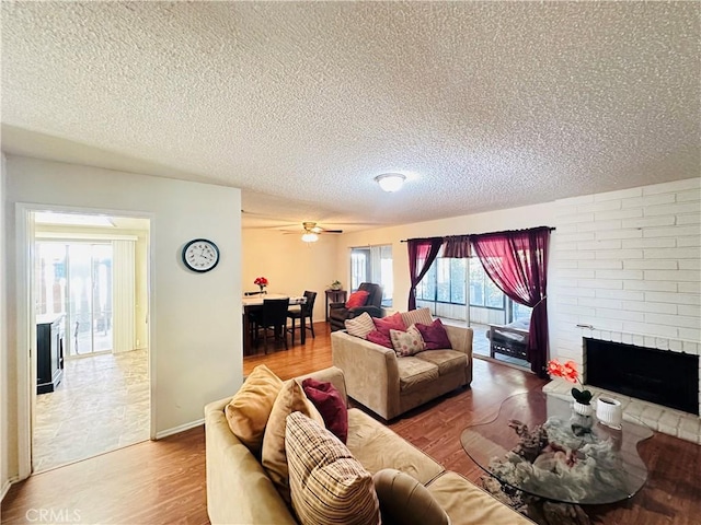 27358 Comwell St, Menifee, CA 92586 - living room with a brick fireplace, a textured ceiling, and wood finished floors