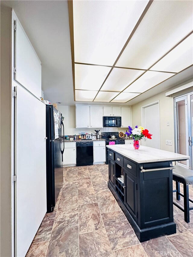 kitchen with white cabinets and black appliances