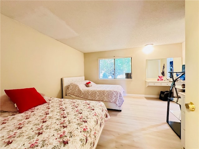 bedroom featuring a textured ceiling and carpet flooring