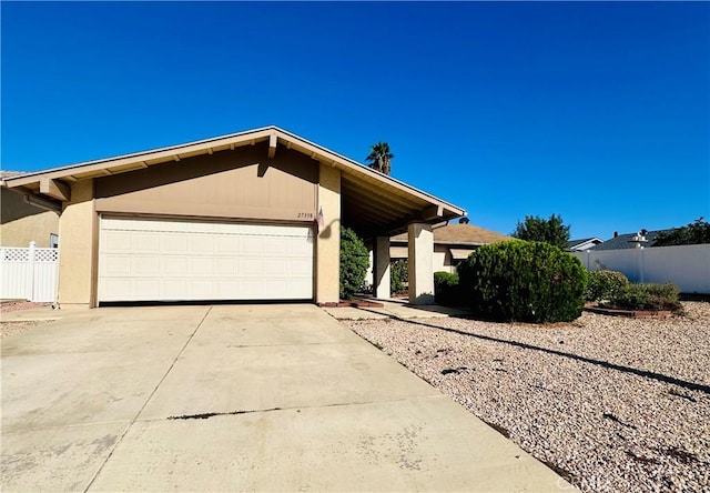 27358 Comwell St, Menifee, CA 92586 - mid-century inspired home featuring an attached garage, fence, stucco siding, and concrete driveway