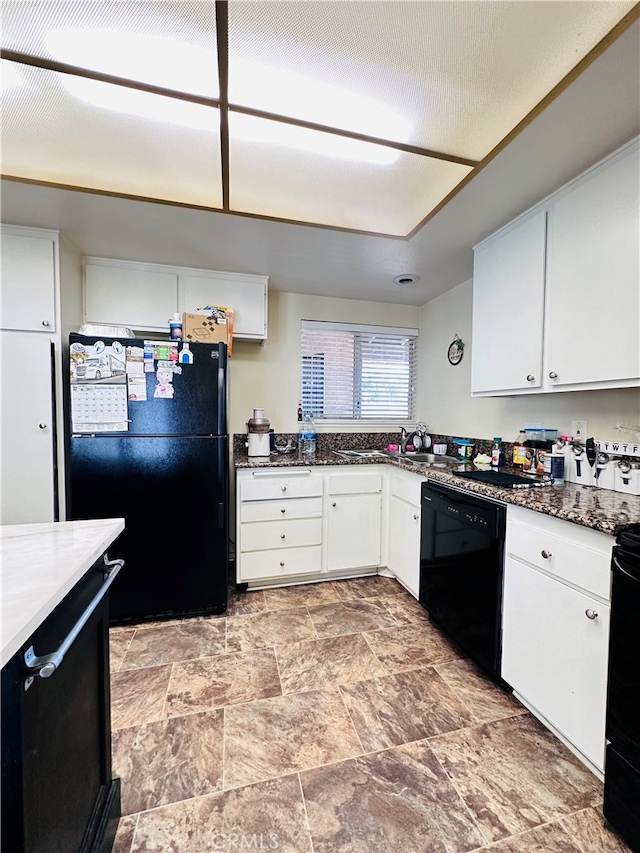 kitchen with black appliances and white cabinetry