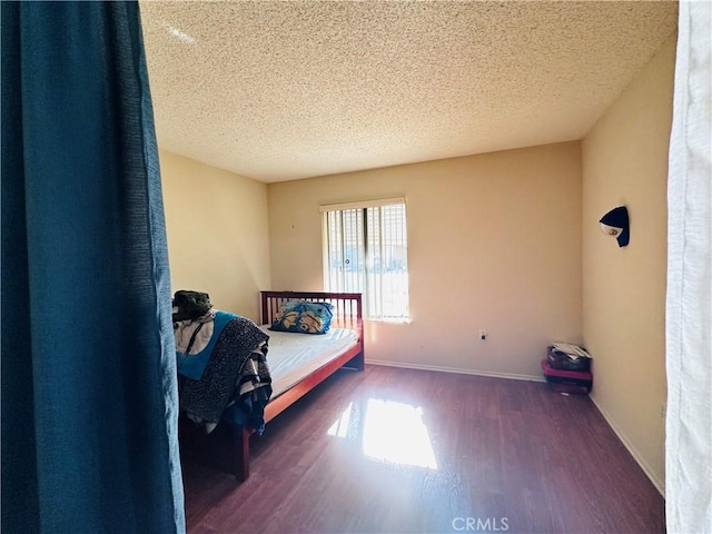 27358 Comwell St, Menifee, CA 92586 - bedroom featuring baseboards, a textured ceiling, and wood finished floors