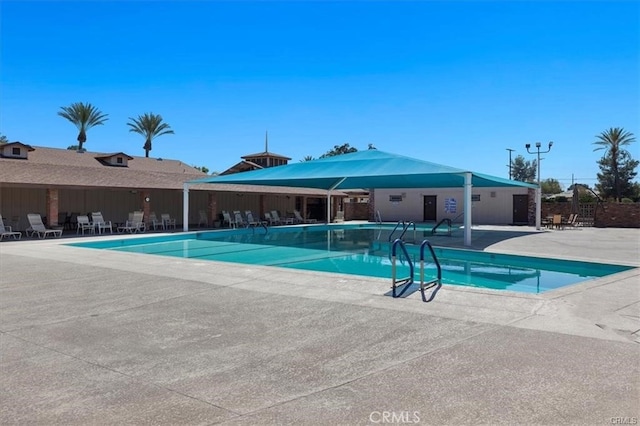 view of swimming pool featuring a patio area