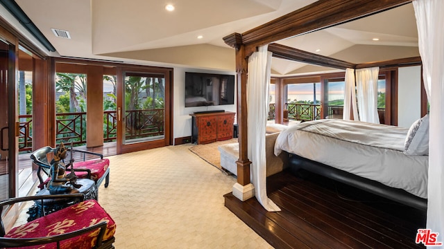 carpeted bedroom featuring lofted ceiling, multiple windows, and access to outside