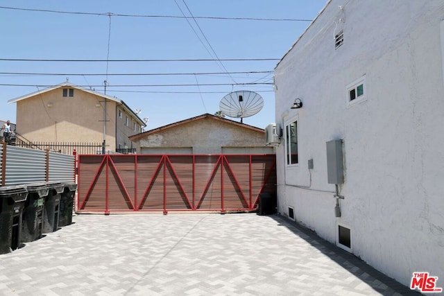 exterior space featuring ac unit and a garage