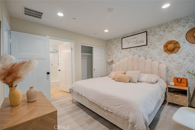 bedroom with a closet and light hardwood / wood-style floors