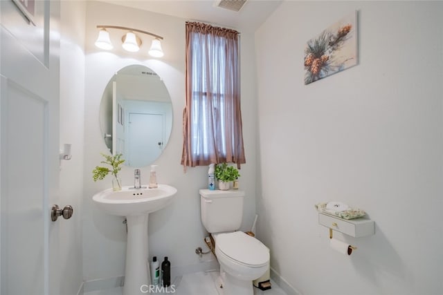 bathroom featuring toilet and sink