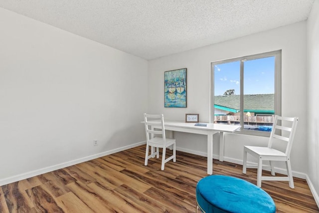 office space with a textured ceiling and hardwood / wood-style flooring