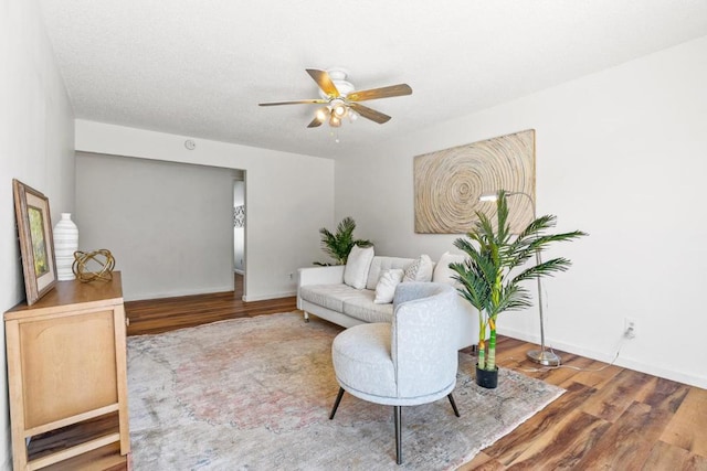 sitting room featuring ceiling fan and hardwood / wood-style floors