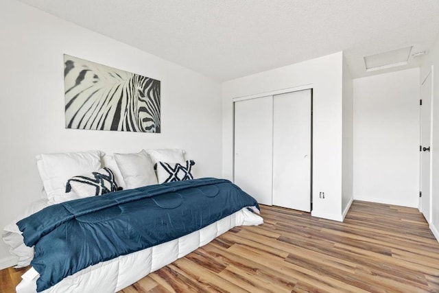 bedroom featuring hardwood / wood-style floors and a closet