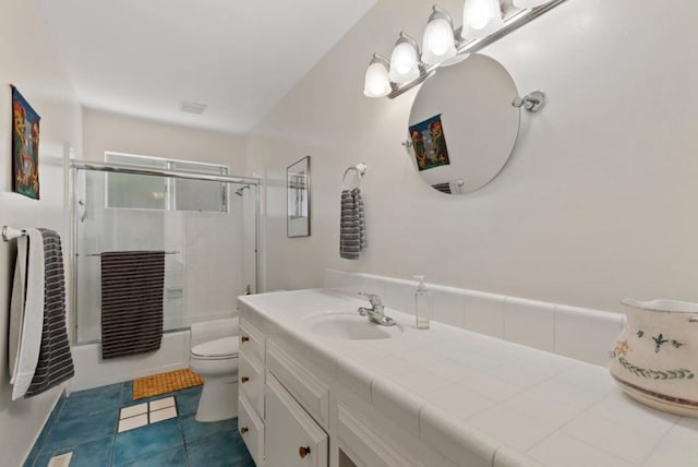 bathroom featuring tile patterned flooring, vanity, and toilet