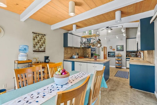 kitchen with white cabinets, beam ceiling, wooden ceiling, and tasteful backsplash