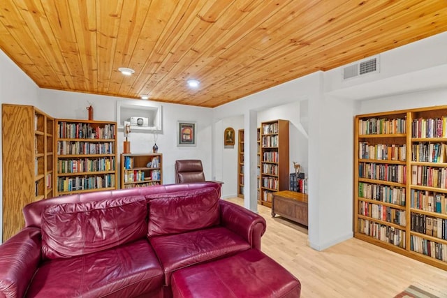 living area with light hardwood / wood-style flooring and wooden ceiling