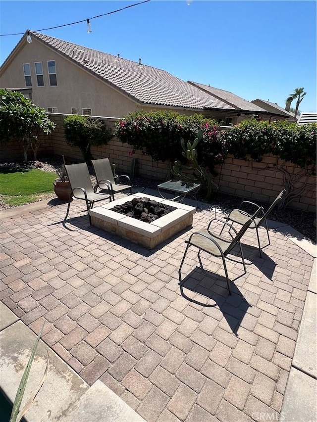 41097 Maiden Ct, Indio, CA 92203 - fenced backyard featuring an outdoor fire pit and a patio area